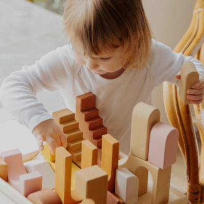 a child playing wooden stackers